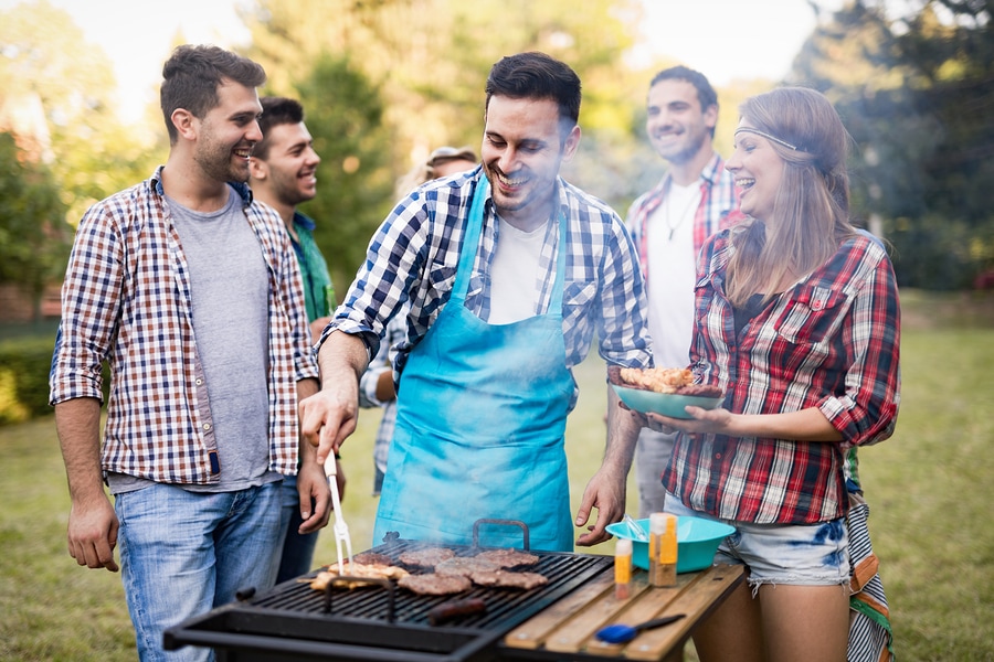 A group of friends enjoys a summer cookout without alcohol.