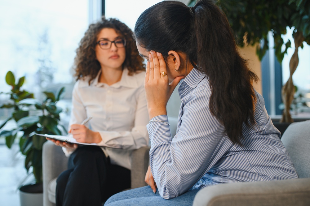 Drug rehab specialist in a licensed and accredited facility speaking to a client